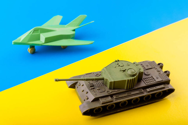 military war plane, fighter plane and tank the background of the Ukrainian flag. The concept of participation of the Ukrainian people in the war with Russia. Not war concept. ending war, go peace - Photo, Image