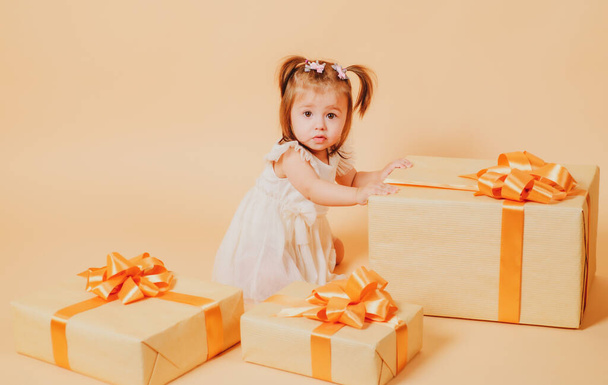 Gifts. Little cute girl with present box. Holidays celebration. - Фото, изображение