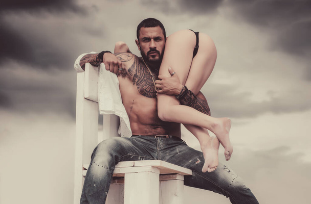 Male perfume for really man. Crazy sex. Beautiful lady and latinos man in erotic pose on sky background. - 写真・画像