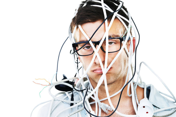 This is not going well. Studio portrait of a young man with cables hanging over his head isolated on white. - Φωτογραφία, εικόνα