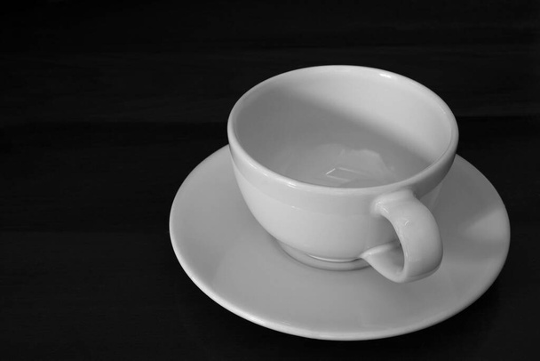 1 empty white tea cup background on black background. - Фото, зображення