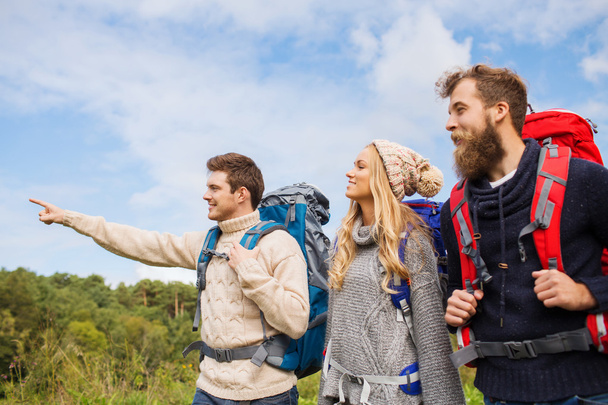 group of smiling friends with backpacks hiking - Fotografie, Obrázek