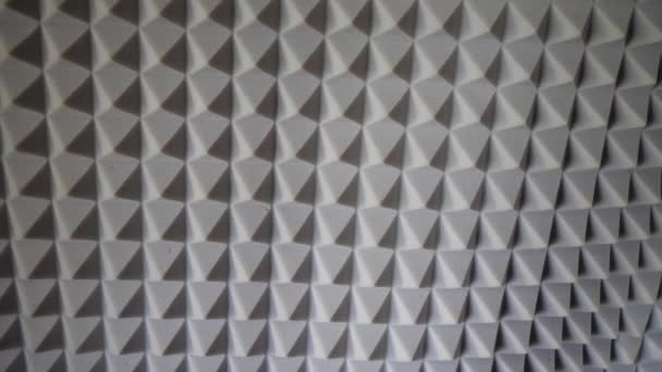 Pyramids of soundproof foam close-up. Noise suppression tool. Gray acoustic foam. Acoustic foam is an open celled foam used for acoustic treatment. It attenuates airborne sound waves. - Footage, Video