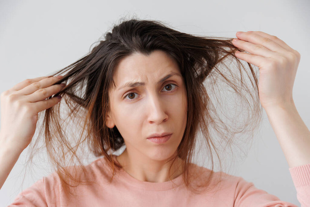 Woman showing hair problems Depressed and Worried. - Fotoğraf, Görsel