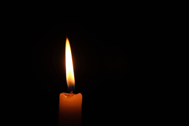 Flame burning candle black background.Concept memory and sorrow - Фото, изображение