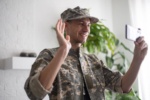 military soldier using mobile phone. letter - Fotografie, Obrázek