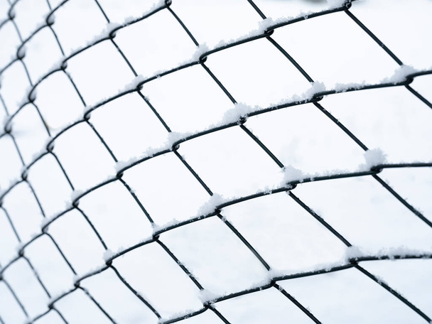 snow covered wire mesh winter background - Photo, Image
