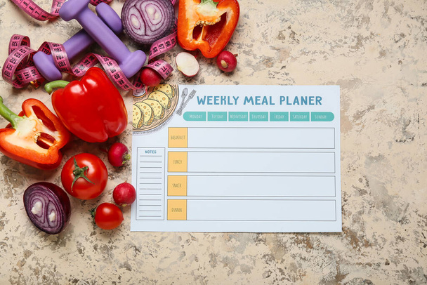 Weekly meal planner and different healthy products on grunge background - Photo, Image