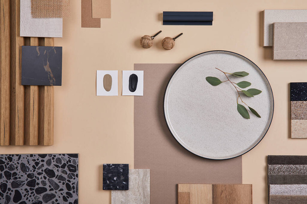 Creative flat lay composition of interior designer and architect moodboard. Textile and paint samples, lamella panels and lastrico tiles. Beige, black and green color palette. Copy space. Template.  - Photo, image