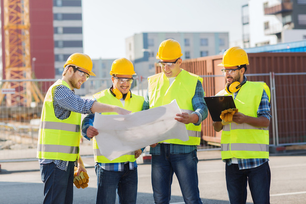 group of builders with tablet pc and blueprint - Foto, imagen