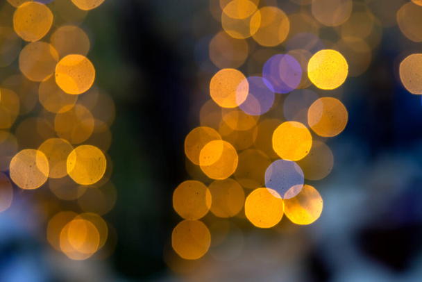 background blurred abstraction of colored lanterns and decorations. bokeh texture of street colored lights - Photo, Image