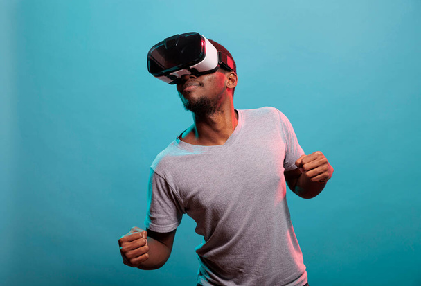 Happy guy playing online game with virtual reality glasses - Foto, Imagem