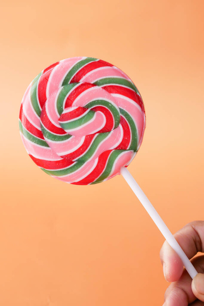 close up of lollipop candy on orange background  - Foto, afbeelding