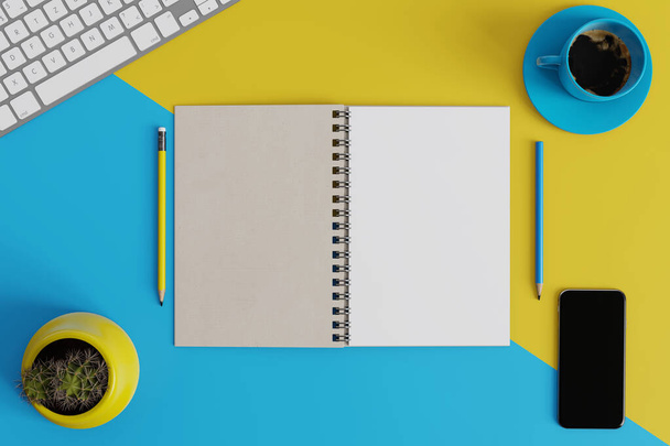 Prepara el espacio de trabajo con el teclado, el cuaderno, el lápiz, la taza azul de café y la olla de cactus amarillo sobre amarillo y azul como fondo. - Foto, Imagen