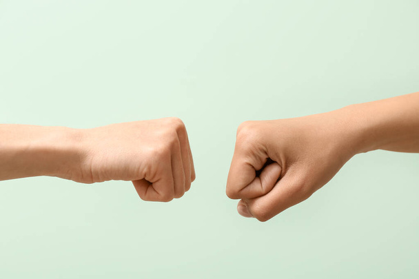 Hands of women with clenched fists on color background - Photo, Image