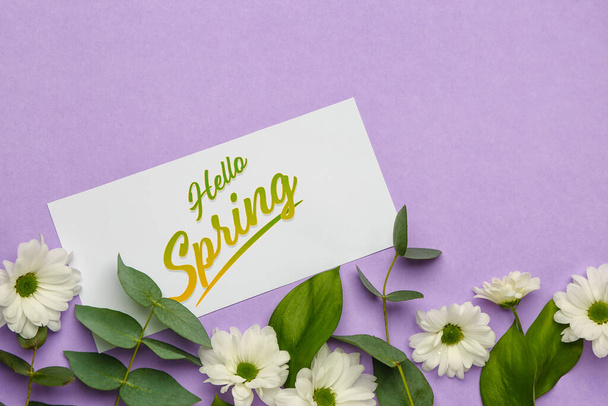 Card with text HELLO SPRING and floral decor on lilac background, closeup - Zdjęcie, obraz