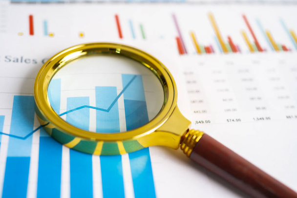 Magnifying glass on charts graphs paper. Financial development, Banking Account, Statistics, Investment Analytic research data economy, Stock exchange trading, Business office company meeting concept. - Photo, Image