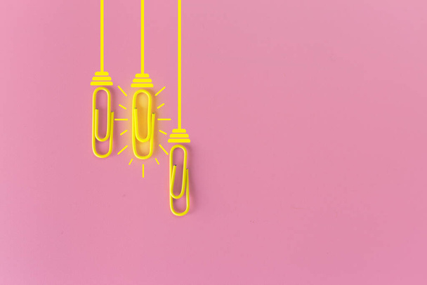 Great ideas concept with paperclip,thinking,creativity,light bulb on blue background,new ideas concept. - 写真・画像