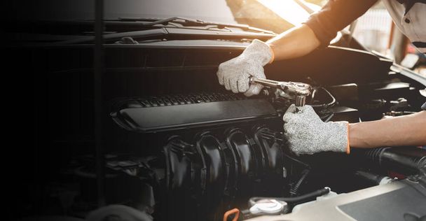 Automobiel monteur reparateur handen repareren van een auto-motor automotive workshop met een moersleutel, auto service en onderhoud, Reparatie service. - Foto, afbeelding