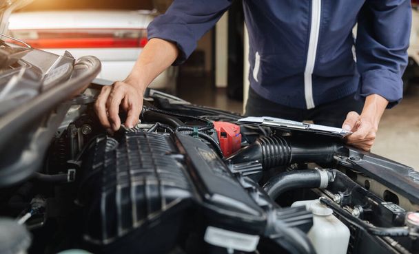 Automobile mechanic repairman hands repairing a car engine automotive workshop with a wrench, car service and maintenance,Repair service. - Fotografie, Obrázek