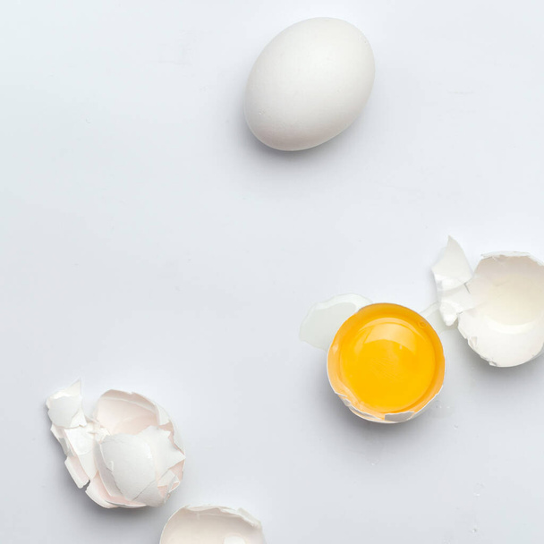 One broken white egg on the white background - Foto, imagen