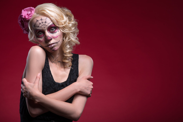 Portrait of young blond girl with Calaveras makeup and a rose fl - Fotografie, Obrázek