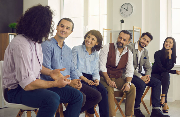 Group of happy interested business people listening to a colleague during a meeting - Photo, Image