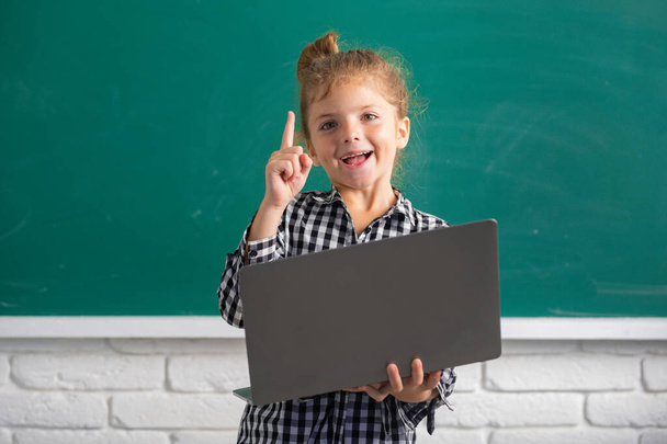 School girl studying math during online lesson in classroom, online education. - Фото, зображення