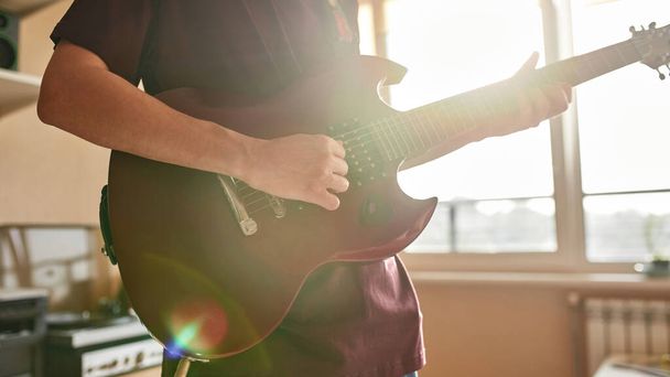 Cropped of man playing notes on electric guitar - Foto, imagen