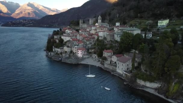 AERIAL VIEW. Small village located along Lake Como next to a marina with moored boats - Travel destination - Dervio, Lombardy, Italy - Footage, Video