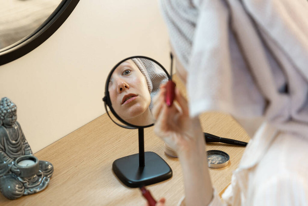 woman applying mascara - 写真・画像
