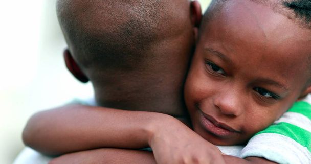 Son hugging father. African kid embracing dad, candid authentic love - Valokuva, kuva