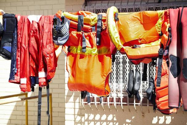 Getting dry in the sunlight. Cropped shot of lifeguard gear hanging on a washing line outside. - Foto, afbeelding