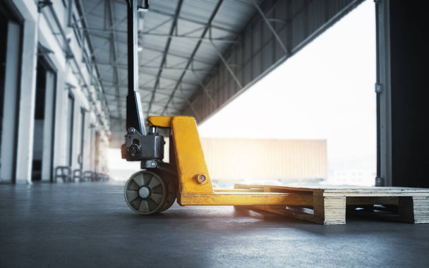 Hand Pallet Truck with Wooden Pallet Rack in The Warehouse - Photo, Image