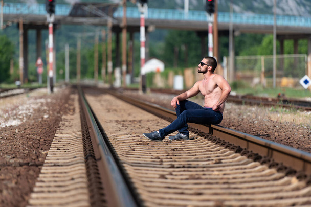 Handsome Beard Man Resting After Posing at Outdoors at Railroad From the Wagon - Fotografie, Obrázek