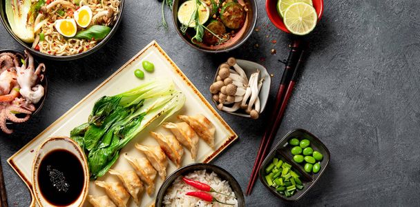 Asian food on dark background, top view wth copy space. - Фото, изображение