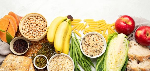 Selection of good carbohydrates sources - vegetables, fruits, grains, legumes, nuts and seeds on white background, top view. - 写真・画像