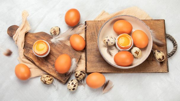 Chicken eggs composition on gray background. Farm products and natural nutrition. Top view, flat lay - Foto, imagen