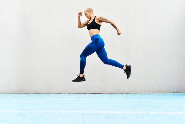 We have lift off. Full length shot of an attractive young female athlete running along the track. - Foto, Bild