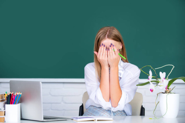 Female student shame embarrassed in school classroom. - Photo, Image