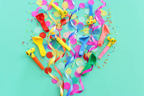 Party colorful confetti over pastel blue background. Top view, flat lay - Fotoğraf, Görsel
