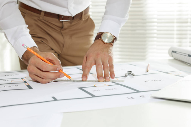 Architect working with construction drawings in office, closeup - Foto, immagini