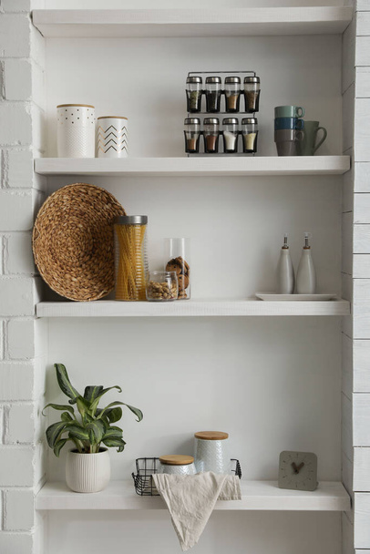 Many shelves with different decor in room. Interior design - Φωτογραφία, εικόνα