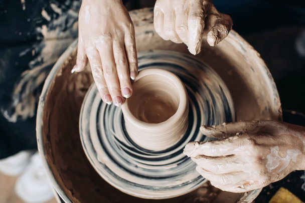 Potter makes a jug on a potter's wheel. Handmade - 写真・画像
