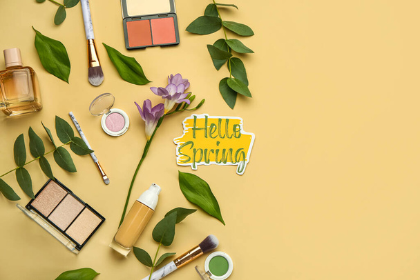 Set of decorative cosmetics and floral decor on color background. Hello spring - Photo, Image