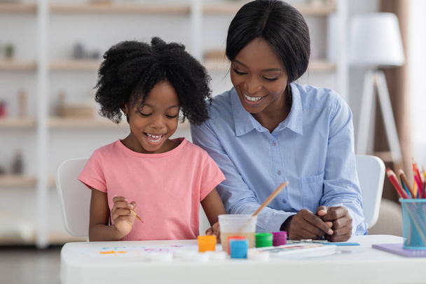 Heureux enfant afro-américain appréciant la peinture à la maternelle - Photo, image