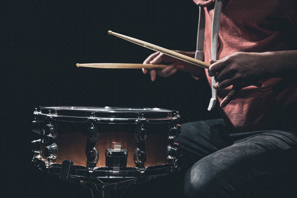 The drummers hands hold drumsticks and play the snare drum. - Photo, Image