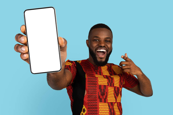 Mobile Mockup. Excited Black Man Pointing At Big Blank Smartphone In Hand - Photo, Image