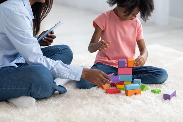 Cropped of kid and child psychotherapist playing with bricks - Foto, imagen