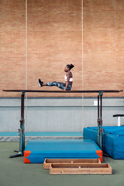 Athlete practicing on parallel bars - Photo, Image